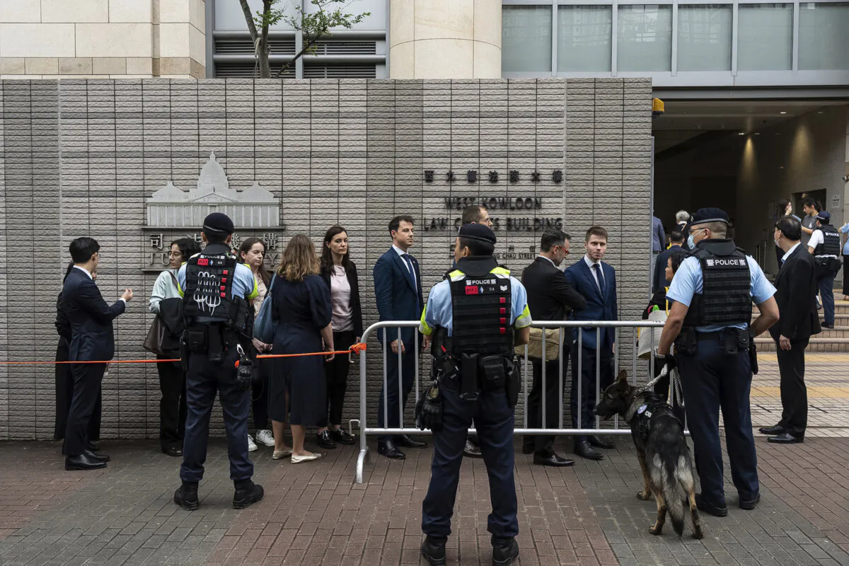 Representatives from various consulates wait outside the West Kowloon Magistrates' Courts in Hong Kong ahead of verdicts in the trial of the “Hong Kong 47” on May 30, 2024. (AP Photo/Chan Long Hei) 