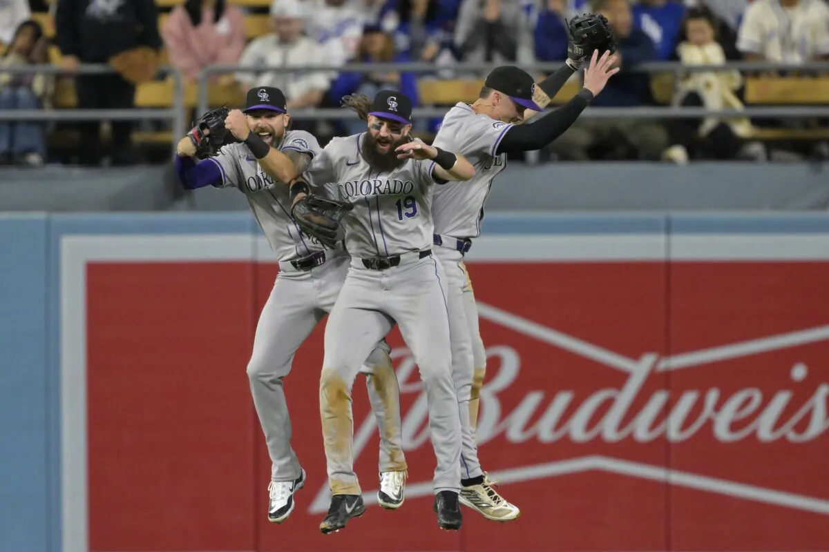 Jake Cave (11), Charlie Blackmon (19) and Brenton Doyle (9) of the Colorado Rockies celebrate after the final out of the ninth inning defeating the Los Angeles Dodgers in Los Angeles on May 31, 2024. (Jayne Kamin–Oncea/Getty Images)