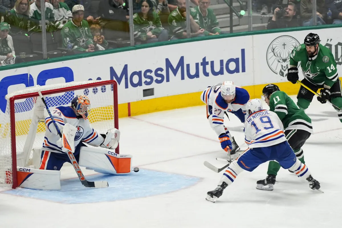 Edmonton Oilers goaltender Stuart Skinner (74) blocks a shot from Dallas Stars center Logan Stankoven (11) as the Oilers' Adam Henrique (19) and Brett Kulak (27) help defednd on the play during the third period of Game 5 of the Western Conference finals in the NHL hockey Stanley Cup playoffs in Dallas on May 31, 2024. (Julio Cortez/AP Photo)