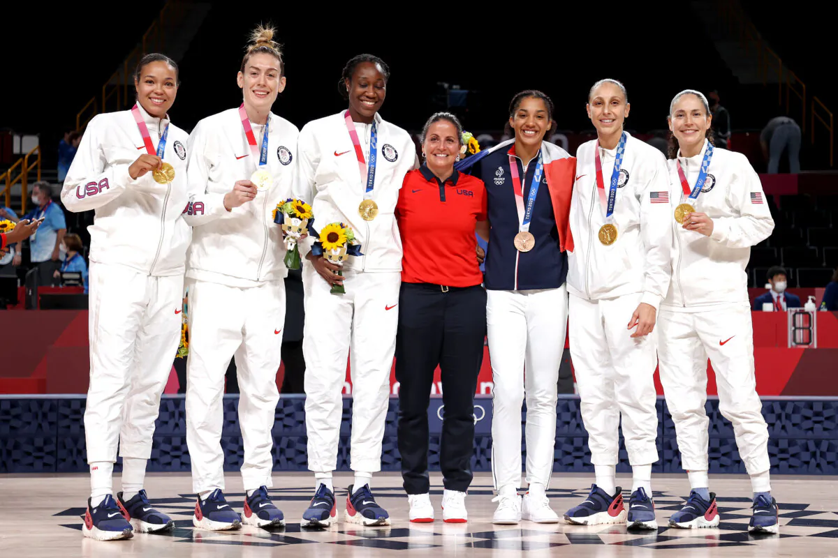 (left to right) Former University of Connecticut players Napheesa Collier, Breanna Stewart, Tina Charles, Cheryl Reeve, Gabby Williams, Diana Taurasi and Sue Bird #6 of Team United States pose for photographs during the Women's Basketball medal ceremony on day sixteen of the 2020 Tokyo Olympic games at Saitama Super Arena on August 08, 2021 in Saitama, Japan. (Gregory Shamus/Getty Images)