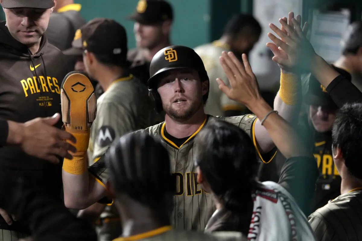 Jake Cronenworth (9) of the San Diego Padres celebrates with teammates after scoring in the eighth inning against the Kansas City Royals in Kansas City on May 31, 2024. (Ed Zurga/Getty Images)