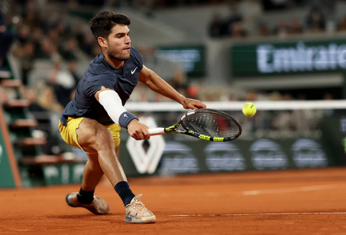 Carlos Alcaraz of Spain stretches to play a forehand against Sebastian Korda of the United States during their Men's Singles Third Round match during Day Six of the 2024 French Open in Paris on May 31, 2024. (Clive Brunskill/Getty Images)