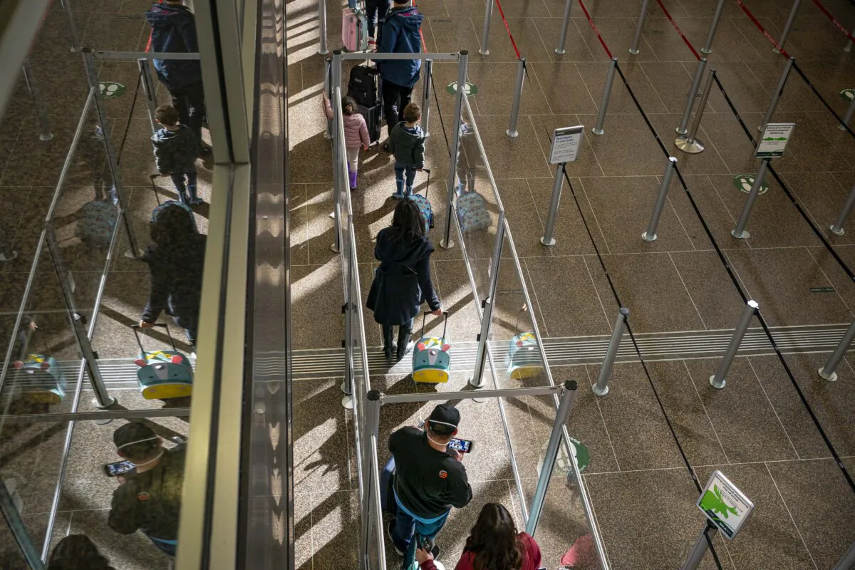 Travelers wait in line for security screening at Seattle-Tacoma International Airport in SeaTac, Washington, on Nov. 29, 2020. (David Ryder/Getty Images)