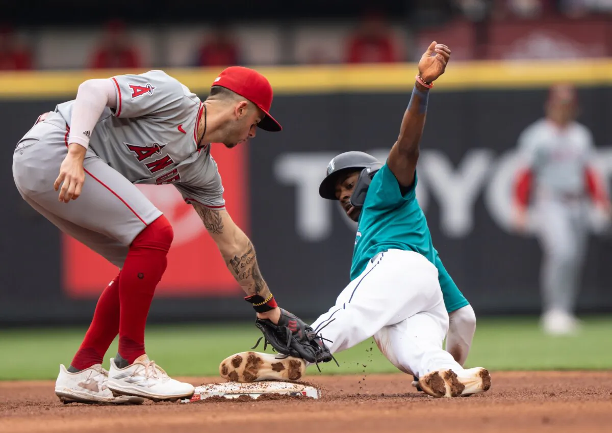 Ryan Bliss (1) of the Seattle Mariners steals second base ahead of a tag by shortstop Zach Neto (9) of the Los Angeles Angels during the third inning of a game in Seattle on June 1, 2024. (Stephen Brashear/Getty Images)