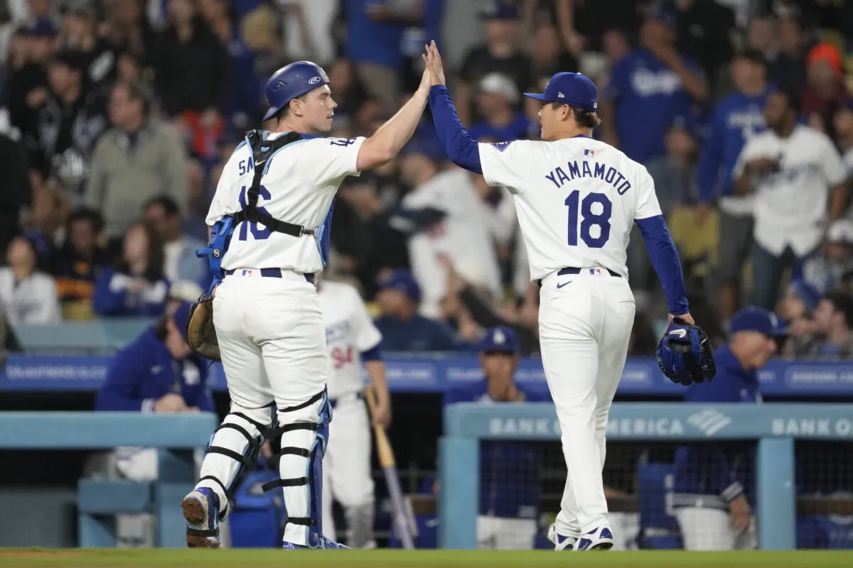Los Angeles Dodgers catcher Will Smith (16) celebrates with starting pitcher Yoshinobu Yamamoto (18) as they walk back to the dugout during the sixth inning of a baseball game against the Colorado Rockies in Los Angeles, on June 1, 2024. (Ashley Landis/AP Photo)