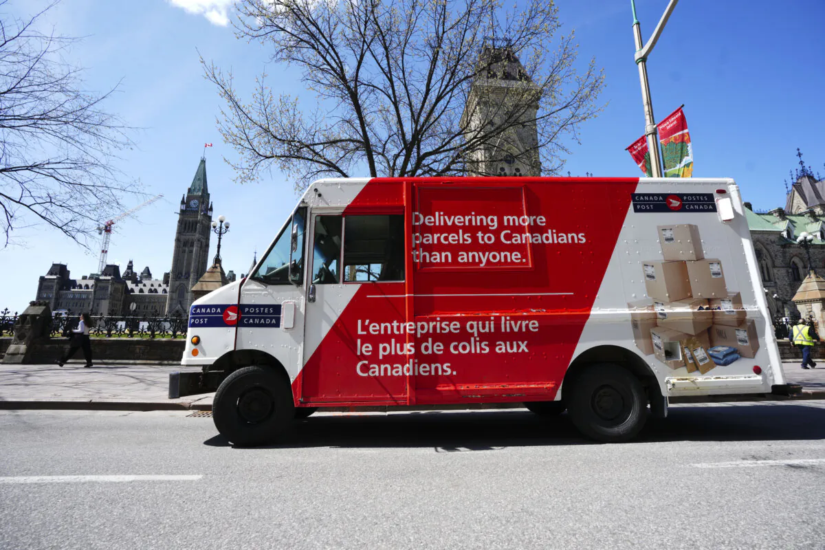 A Canada Post parcel delivery vehicle parked on Wellington Street and Parliament Hill in Ottawa on May 5, 2022. (The Canadian Press/Sean Kilpatrick)
