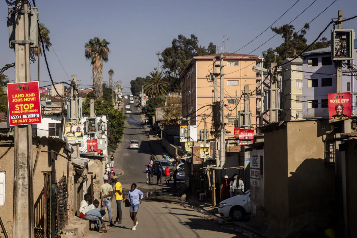 People hang out in the street in the Alexandra township on May 31, 2024, in Johannesburg. (Chris McGrath/Getty Images)