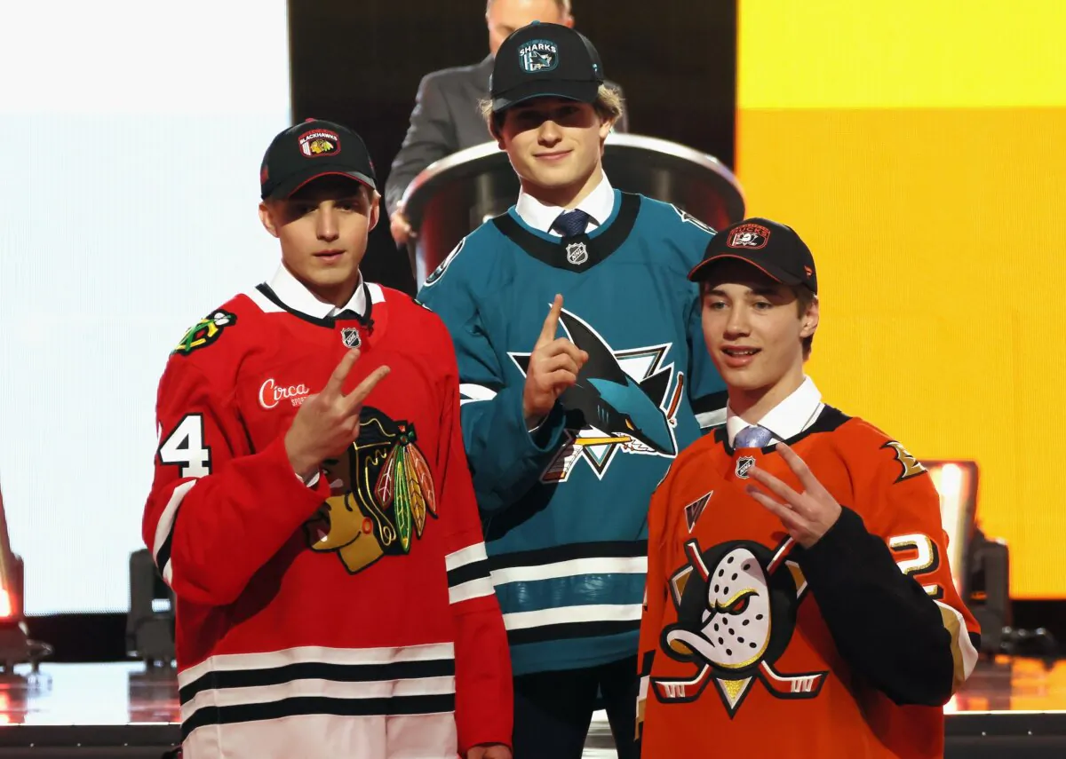 Artyom Levshunov, second overall pick of the Chicago Blackhawks, Macklin Celebrini, first overall pick of the San Jose Sharks, and Beckett Sennecke, third overall pick of the Anaheim Ducks, pose for a group photo during the first round of the 2024 NHL Draft in Las Vegas on June 28, 2024. (Bruce Bennett/Getty Images)
