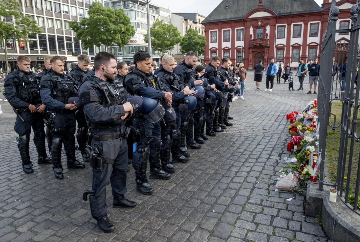 German police officers commemorate a colleague in Mannheim Germany, after learning that a police officer, who was stabbed two days ago there has died on Sunday, on June 2, 2024. (Michael Probst/AP Photo)