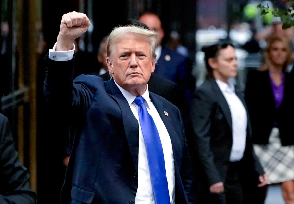 Former President and Republican presidential candidate Donald Trump holds up a fist as he arrives back at Trump Tower after being convicted in his criminal trial in New York City, on May 30, 2024. (Timothy A. Clary/AFP via Getty Images)