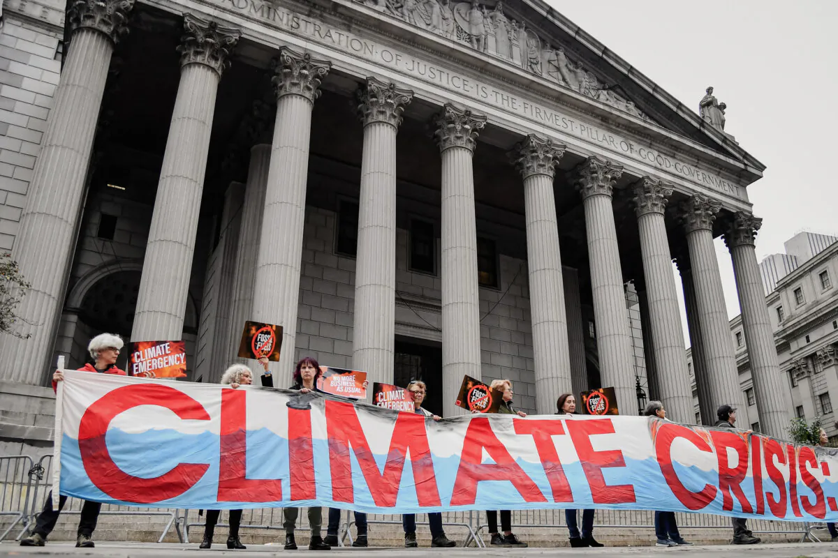 Climate activists protest during an Exxon Mobil trial outside the New York State Supreme Court building, in New York City, in this file photo. (Angela Weiss/AFP via Getty Images)