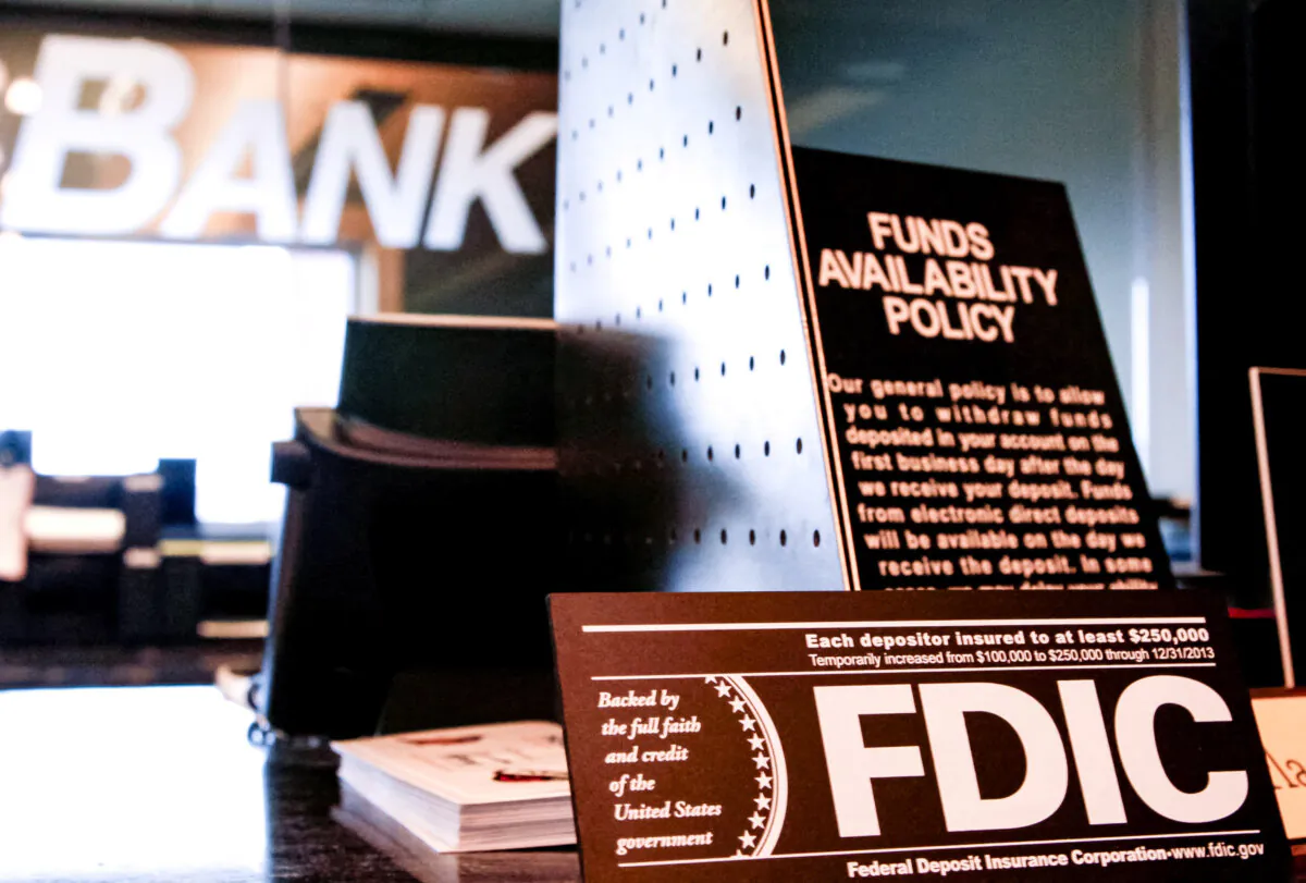 Signs explaining Federal Deposit Insurance Corporation (FDIC) policy and other banking policies are shown on the counter of a bank in Westminster, Colo., on Nov. 3, 2009. (Rick Wilking/Reuters)