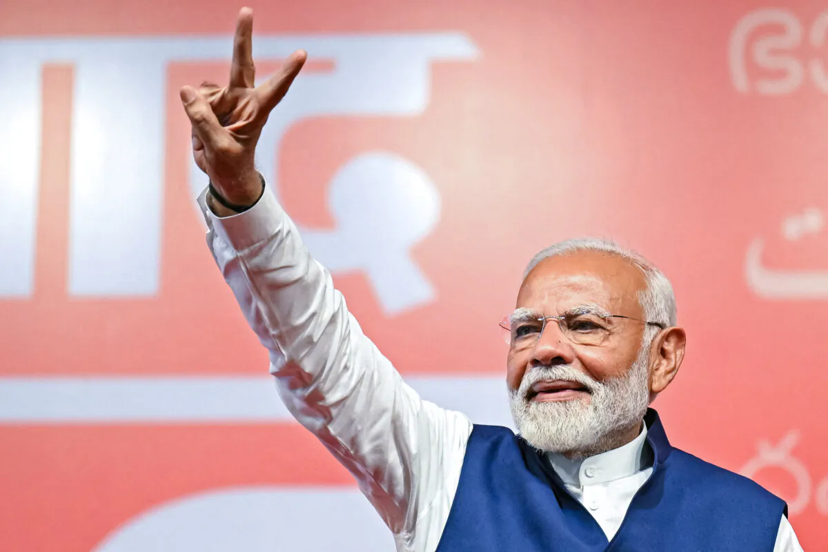 India's Prime Minister Narendra Modi flashes victory sign at the Bharatiya Janata Party (BJP) headquarters to celebrate the party's win in country's general election, in New Delhi on June 4, 2024. (Money Sharma/AFP via Getty Images)