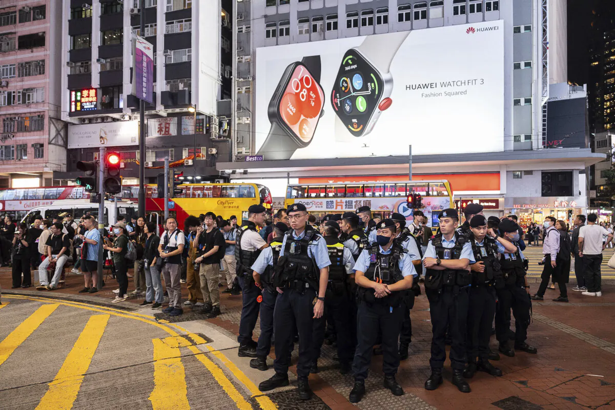 Police officers stand guard in Causeway Bay area, on the 35th anniversary of China's Tiananmen Square crackdown, in Hong Kong, on June 4, 2024. (The Associated Press/Chan Long Hei)