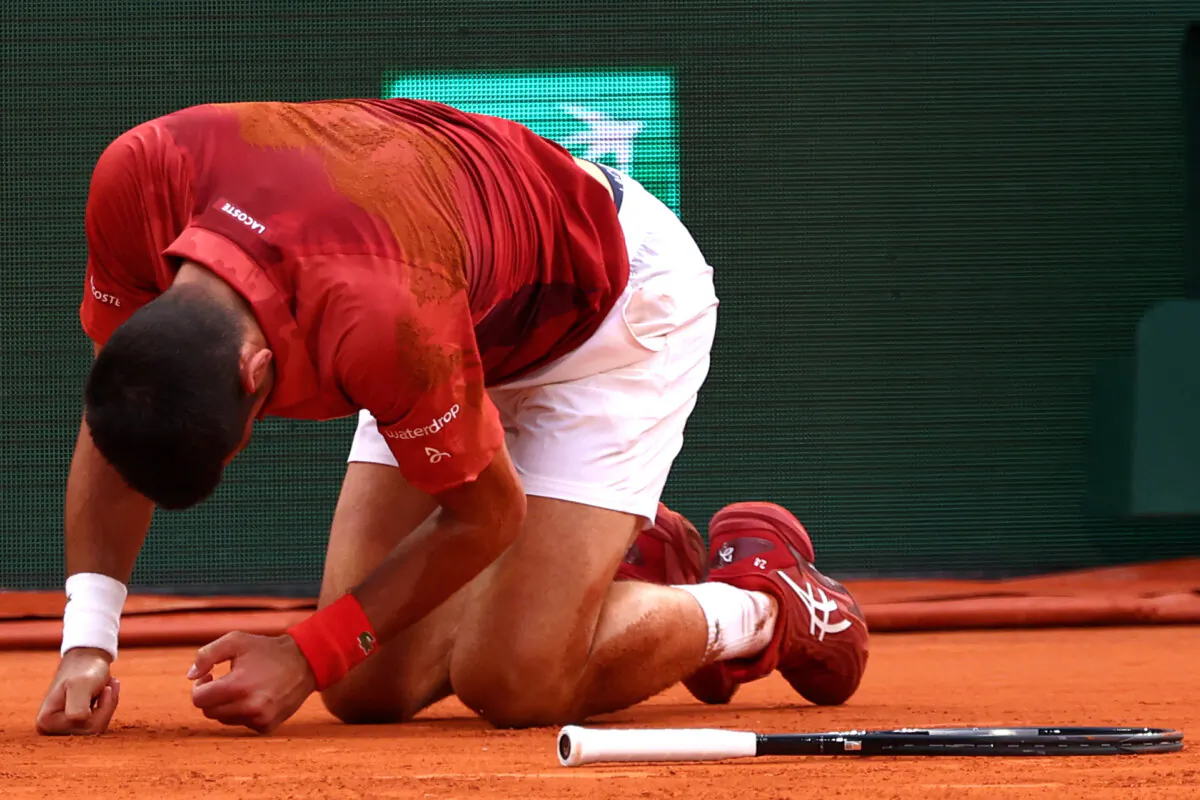 Novak Djokovic reacts after falling during his French Open match against Francisco Cerundolo in Paris on June 3, 2024. (Emmanuel Dunand/AFP via Getty Images)