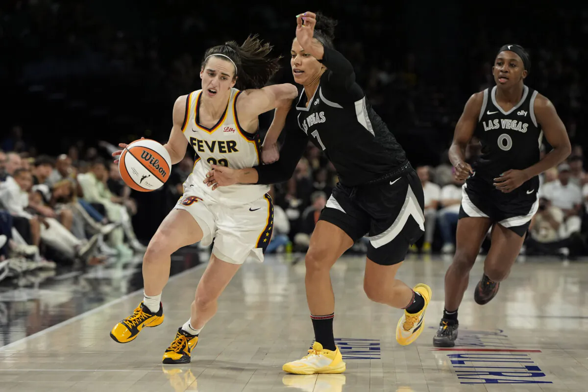 Indiana Fever guard Caitlin Clark (22) drives against Las Vegas Aces forward Alysha Clark (7) during the second half of a WNBA basketball game in Las Vegas on May 25, 2024. (John Locher/AP Photo)