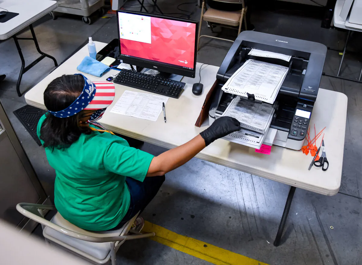 A Clark County election worker scans mail-in ballots at the Clark County Election Department in North Las Vegas, Nev., on Nov. 7, 2020. (Ethan Miller/Getty Images)