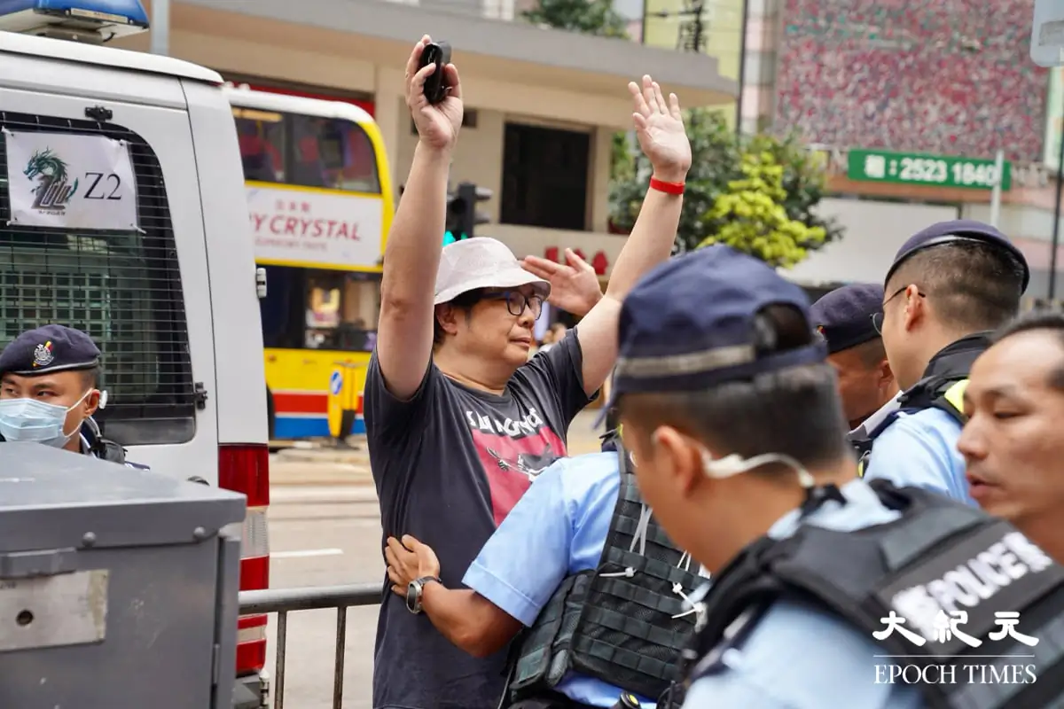 Pedestrians in Causeway Bay were constantly being stopped and searched by Hong Kong police on June 4, 2024. (Yu Gang/The Epoch Times)