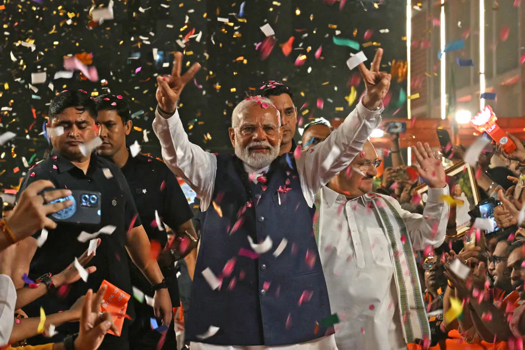 India's Prime Minister Narendra Modi flashes victory sign as he arrives at the Bharatiya Janata Party (BJP) headquarters to celebrate the party's win in country's general election, in New Delhi, India, on June 4, 2024. (Arun Sankar/AFP via Getty Images)