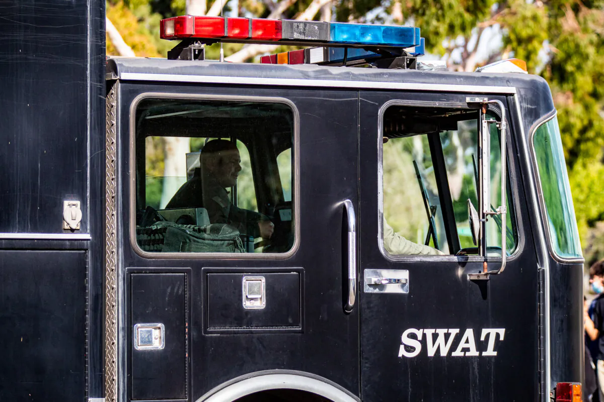 A SWAT team performs an operation in Santa Ana, Calif., on March 10, 2022. (John Fredricks/The Epoch Times)