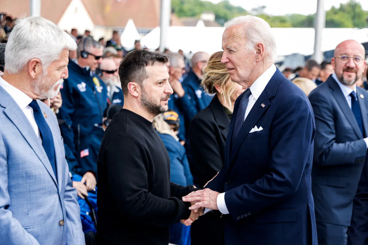 U.S. President Joe Biden (R) shakes hands with Ukraine’s President Volodymyr Zelenskyy during the International commemorative ceremony at Omaha Beach marking the 80th anniversary of the World War II "D-Day" Allied landings in Normandy, in Saint-Laurent-sur-Mer, in northwestern France, on June 6, 2024. (Ludovic Marin/AFP via Getty Images)