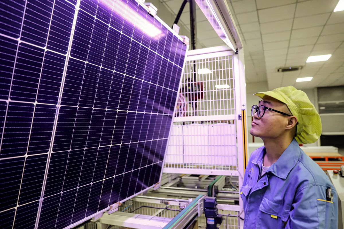 A worker produces solar photovoltaic modules used for solar panels at a workshop in Huaian city, in eastern China's Jiangsu Province, on Sept. 5, 2023. (STR/AFP via Getty Images)