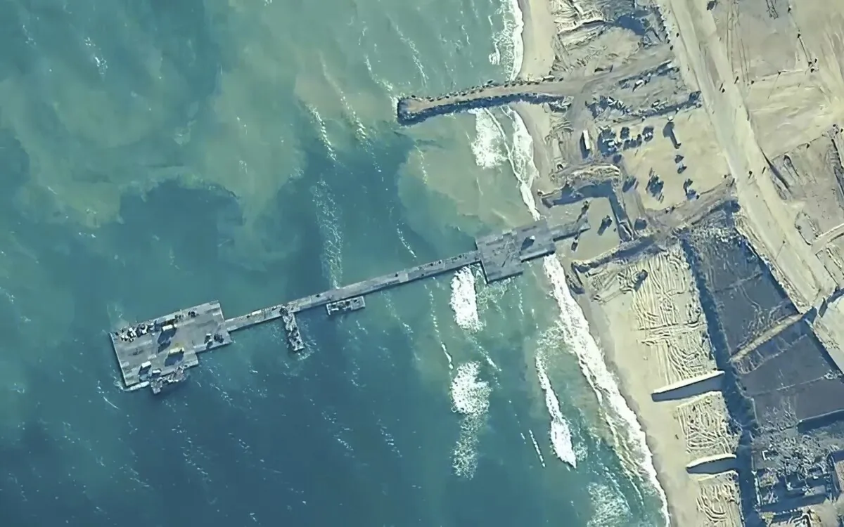 U.S. Army soldiers assigned to the 7th Transportation Brigade (Expeditionary), U.S. Navy sailors assigned to Amphibious Construction Battalion 1, and Israel Defense Forces placing the Trident Pier on the coast of Gaza Strip on May 16, 2024. (U.S. Central Command via AP)