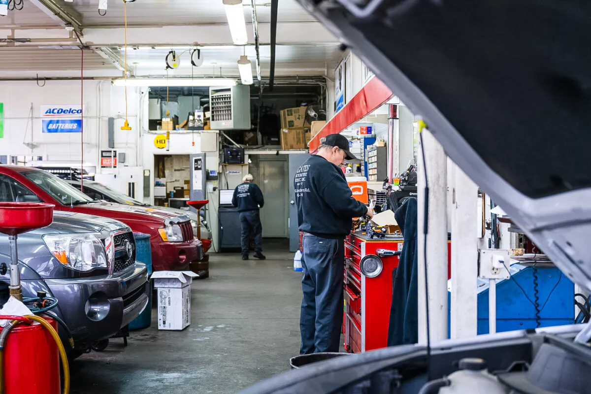 An auto mechanic stands at a workbench at an automotive service in Louisville, Ky., on Jan. 13, 2022. (Jon Cherry/Getty Images)