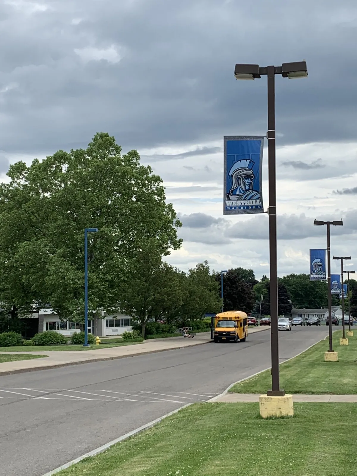 The Westhill Warriors High School name and mascot are seen on a banner affixed to a light pole in the school parking lot on June 6, 2024, in Syracuse, N.Y. (Aaron Gifford / The Epoch Times)