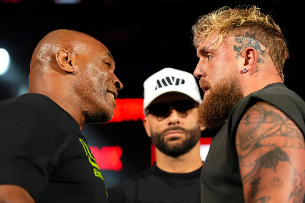 (L–R) Mike Tyson, Nakisa Bidarian, and Jake Paul pose onstage during the Jake Paul vs. Mike Tyson Boxing match Arlington press conference at Texas Live! in Arlington, Texas, on May 16, 2024. (Cooper Neill/Getty Images for Netflix)