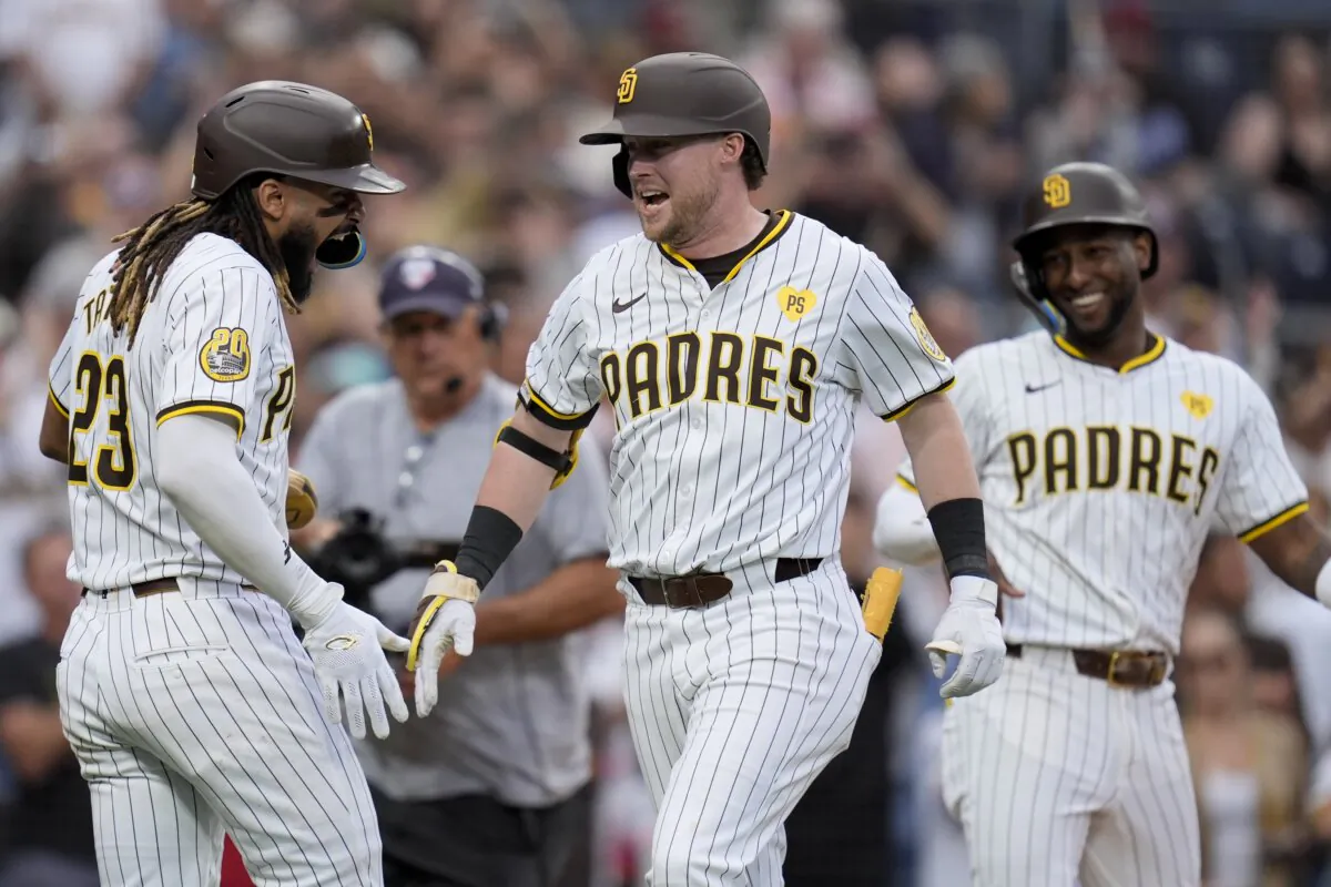 San Diego Padres' Jake Cronenworth (C) celebrates with teammates Jurickson Profar, and Fernando Tatis Jr. after hitting a three-run home run during the fourth inning of a baseball game against the Arizona Diamondbacks in San Diego on June 8, 2024. (Gregory Bull/AP Photo)