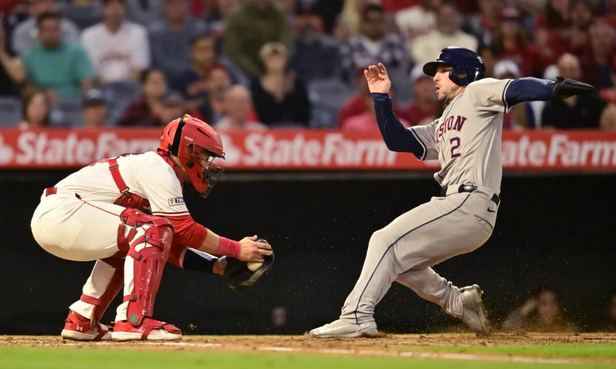 Matt Thaiss (21) of the Los Angeles Angels tags out Alex Bregman (2) of the Houston Astros at home plate in the third inning in Anaheim, Calif., on June 8, 2024. (John McCoy/Getty Images)