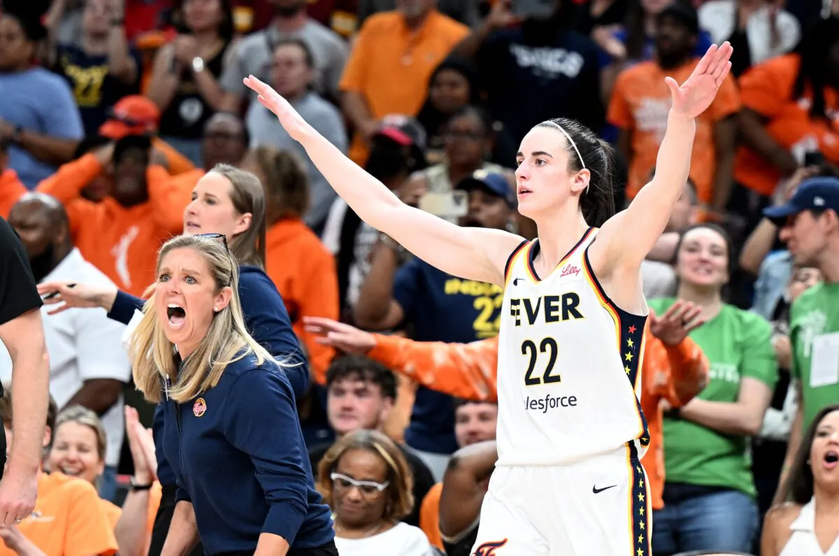 Indiana Fever head coach Christie Sides (L)and Caitlin Clark, who scored 30 points, celebrate after a 85–83 victory against the Washington Mystics in Washington on June 7, 2024. (Greg Fiume/Getty Images)