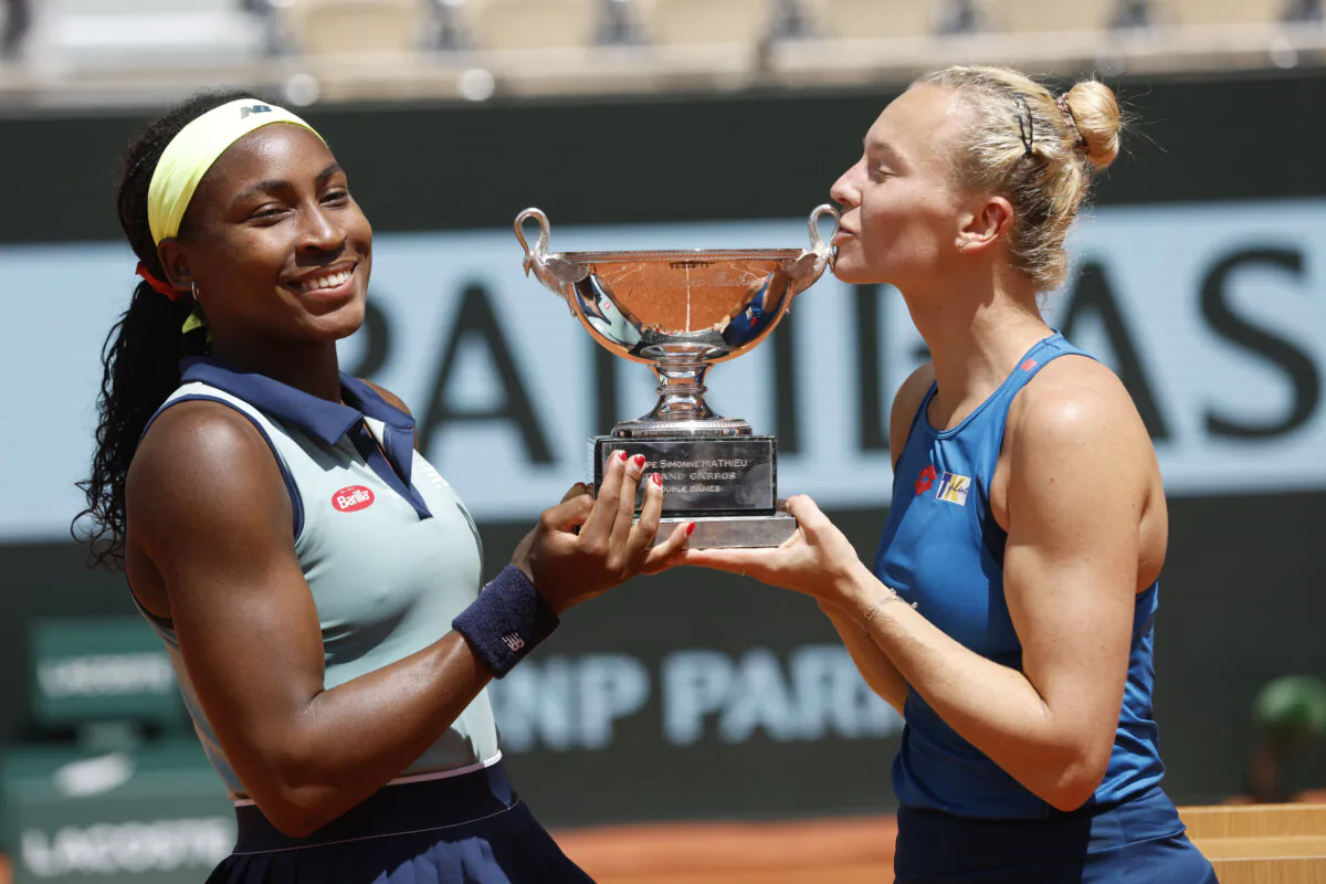 Coco Gauff of the United States (L) and Katerina Siniakova of the Czech Republic pose with the trophy as they won the women's doubles final match of the French Open tennis tournament in Paris on June 9, 2024. (Jean-Francois Badias/AP Photo)