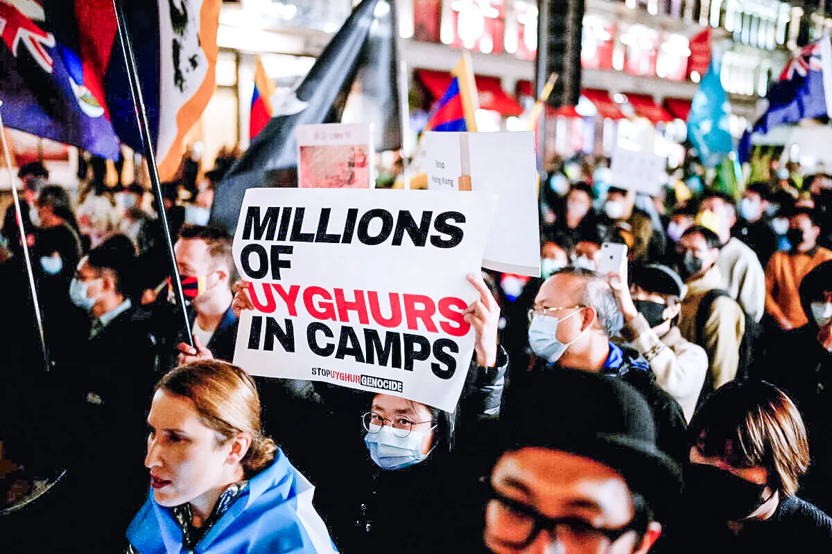 Demonstrators supporting Uyghurs, Tibetans, and Hong Kongers take part in a protest against the Chinese Communist Party as they march along Regent Street towards the Chinese Embassy in London on Oct. 1, 2021. (Matt Dunham/AP Photo)