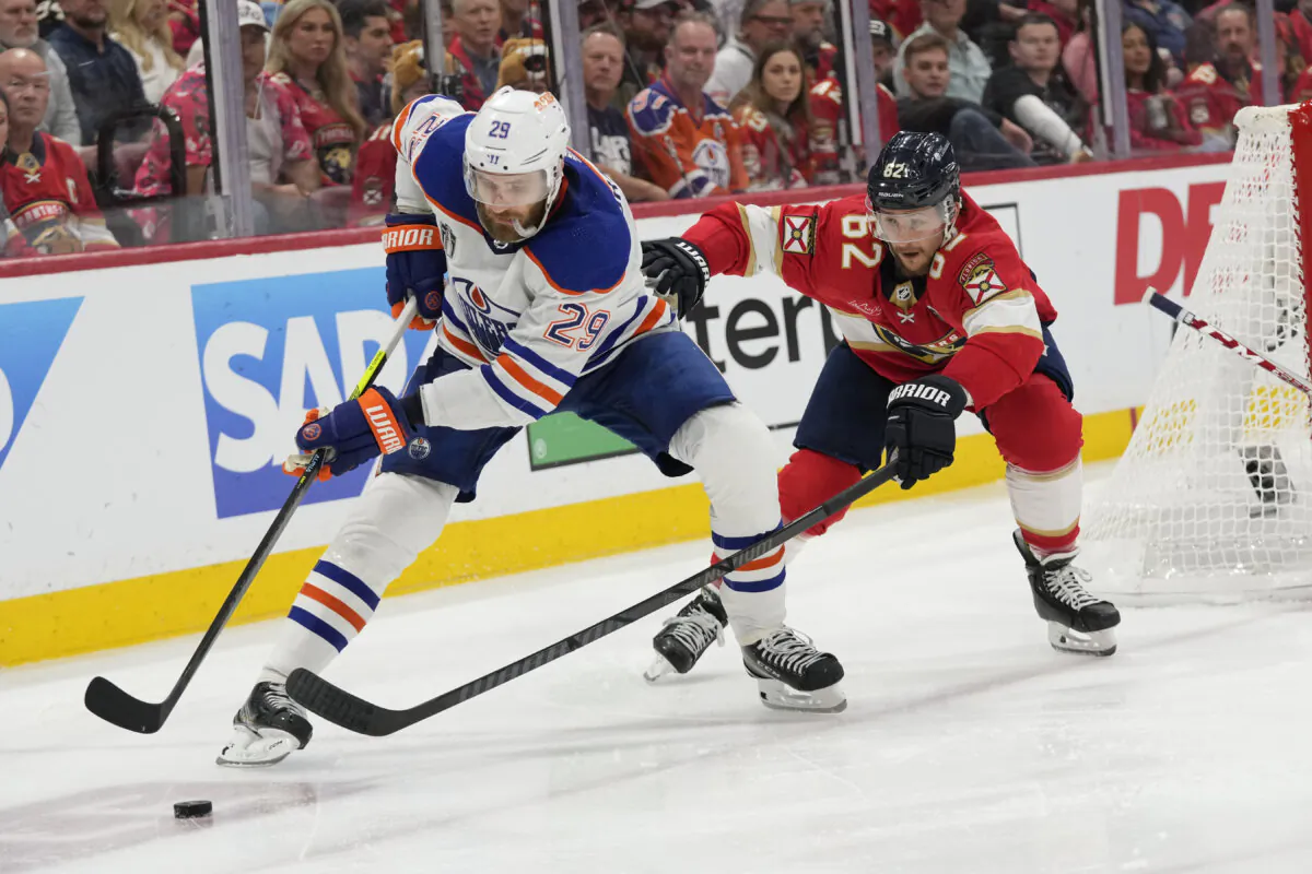Leon Draisaitl (L) of the Edmonton Oilers shields the puck from Florida Panthers defenseman Brandon Montour during Game 2 of the Stanley Cup Final in Sunrise, Fla., on June 10, 2024. (Wilfredo Lee/AP Photo)