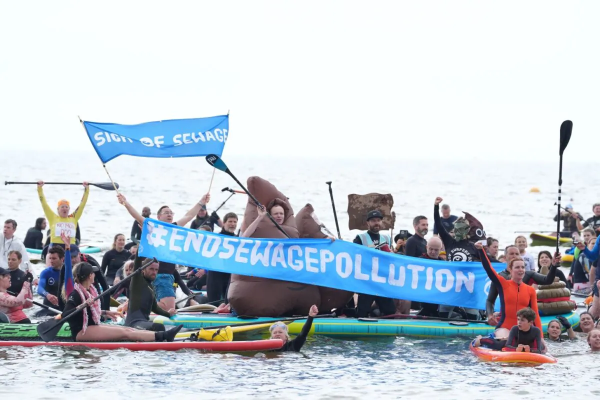 Protesters during a Surfers Against Sewage paddle-out Protest in Brighton on May 18, 2024. (Gareth Fuller/PA Wire)