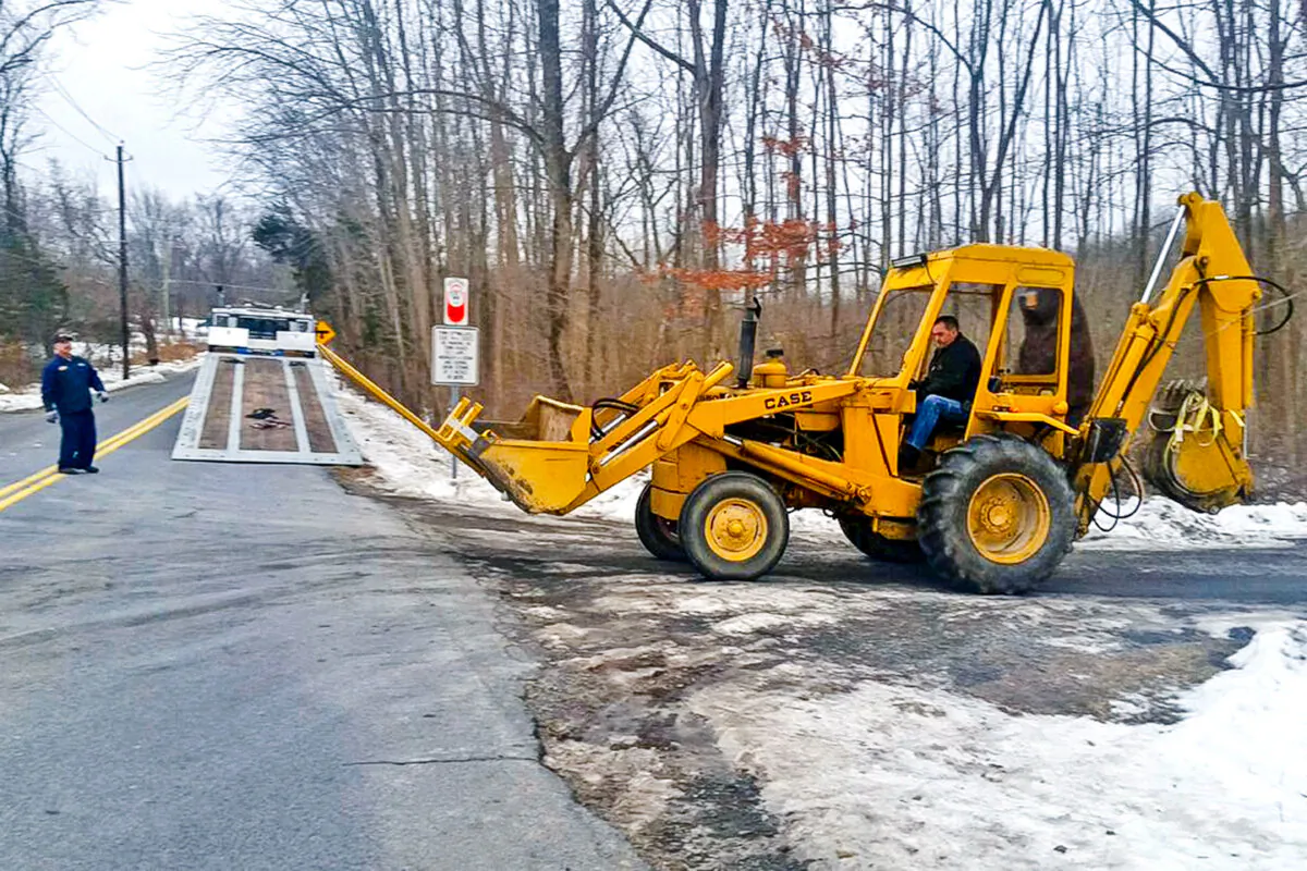 FBI investigators remove a backhoe seized from the Crawford, New York property of former Briarcliff Manor Police officer Nicholas Tartaglione on Dec. 21, 2016. (James Nani/Times Herald-Record via AP)