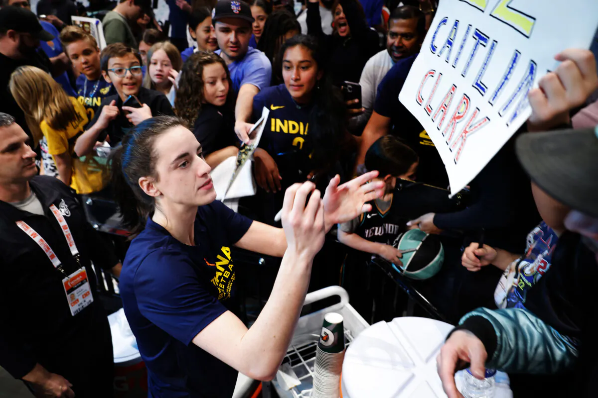 Indiana Fever guard Caitlin Clark signs autographs for fans before the start of WNBA basketball game against the New York Liberty in New York on May 18, 2024. (Noah K. Murray/AP Photo)