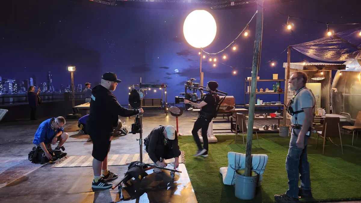 A movie crew for the production of "Hostile Takeover" works at the Johns Hopkins Soundstage in front of the LED Volume Wall and Ecosystem in Regina, Sask., on May 28, 2024. (Lee Harding for The Epoch Times)