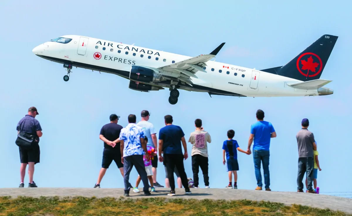 People look on as a plane takes off at Montréal-Trudeau International Airport in a file photo. (The Canadian Press/Graham Hughes)