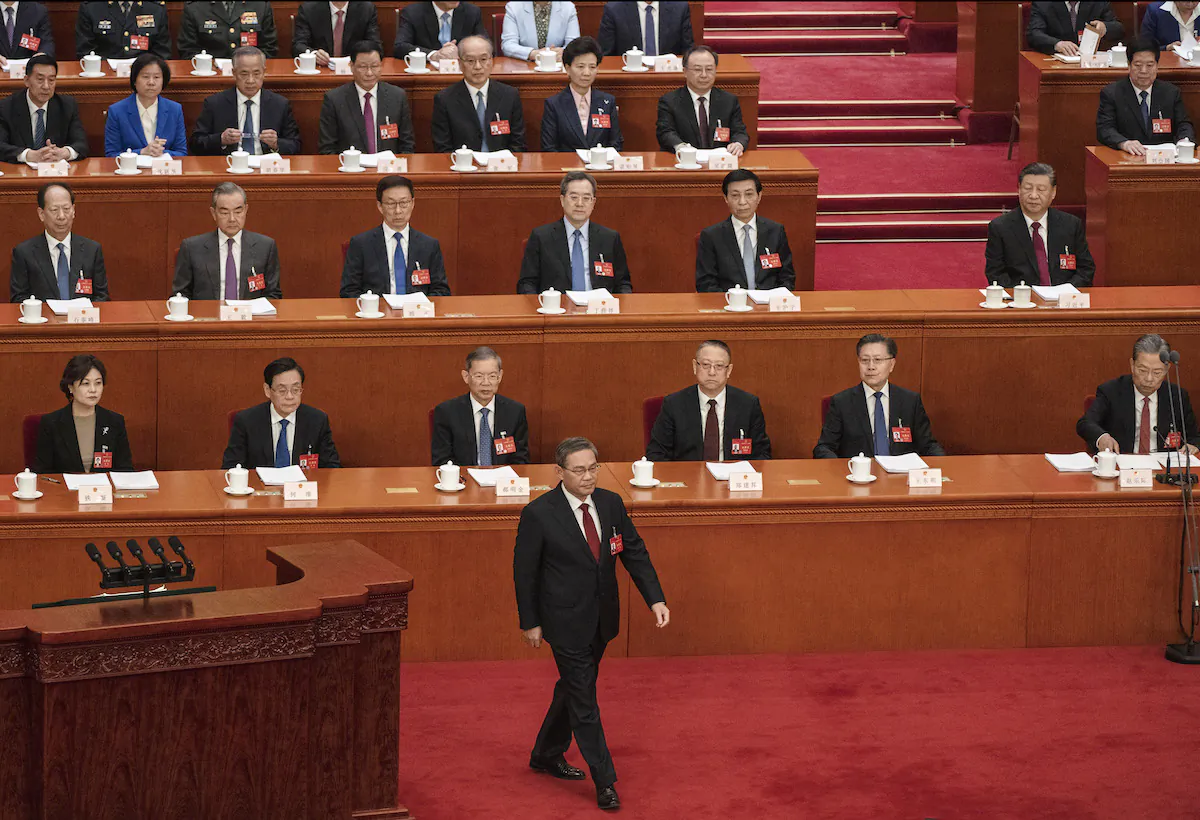 Chinese Premier Li Qiang (C) walks on the stage before his speech at the opening of the NPC, or National People's Congress, at the Great Hall of the People in Beijing, China on March 5, 2024. (Kevin Frayer/Getty Images)