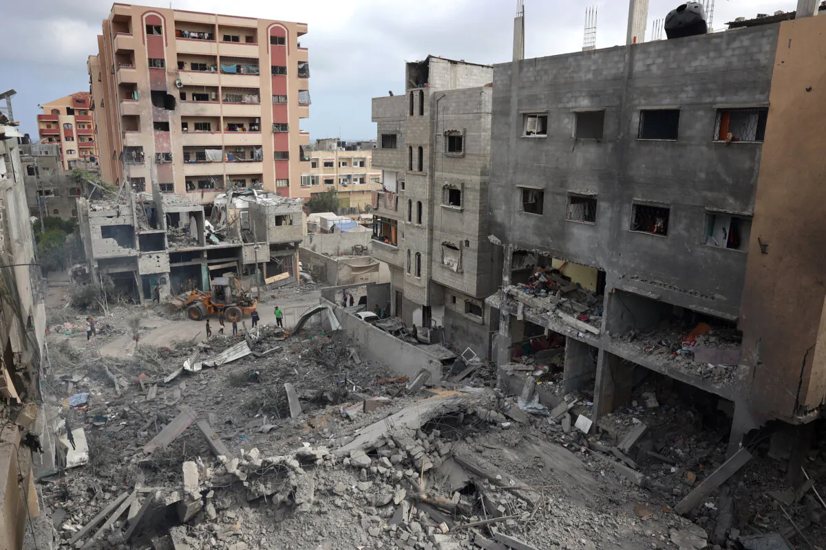 Palestinians inspect the damage and debris a day after an operation by the Israeli Special Forces in the Nuseirat camp, in the central Gaza Strip on June 9, 2024, amid the ongoing conflict between Israel and the Palestinian Hamas militant group. (Eyad Baba/Getty Images)