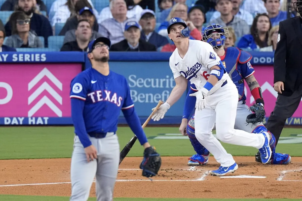 Los Angeles Dodgers' Will Smith (C) heads to first for a three-run home run as Texas Rangers starting pitcher Dane Dunning (L) and catcher Jonah Heim (R) watch along during the first inning of a baseball game in Los Angeles on June 11, 2024. (Mark J. Terrill/AP Photo)