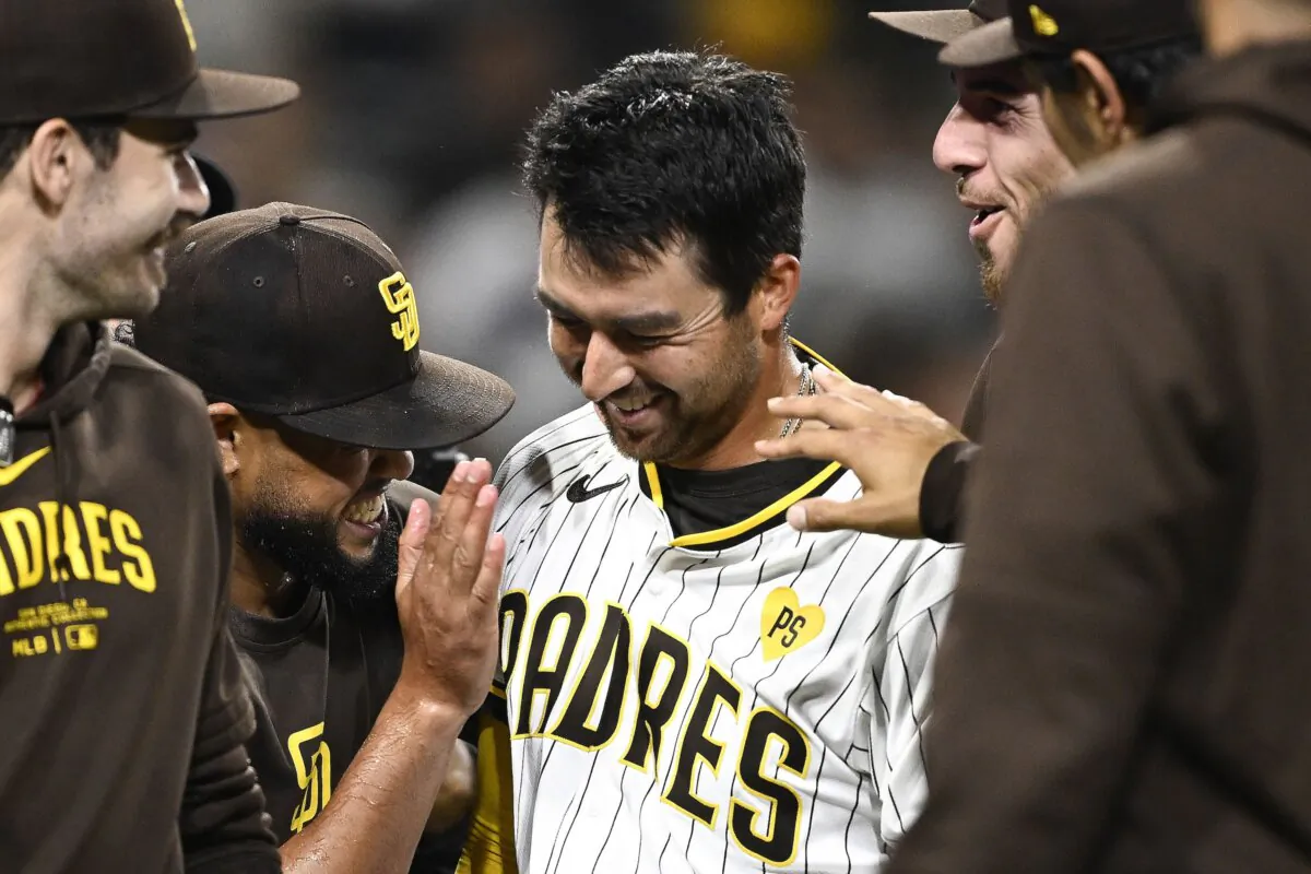 Kyle Higashioka (20) of the San Diego Padres is congratulated after hitting a walk-off solo home run during the ninth inning of a baseball game against the Oakland Athletics in San Diego on June 11, 2024. (Denis Poroy/Getty Images)