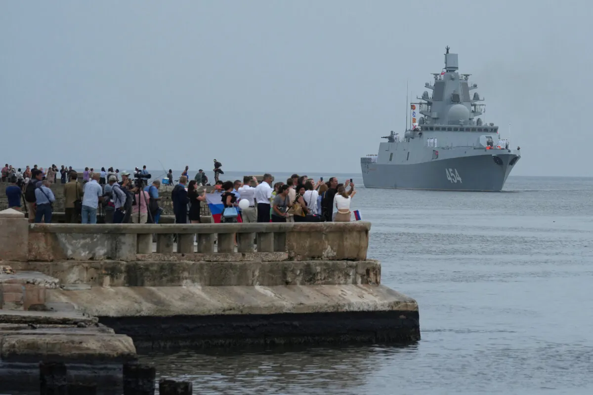 People watch Russian frigate Admiral Gorshkov as it enters Havana’s bay, Cuba, on June 12, 2024. (Alexandre Meneghini/Reuters)