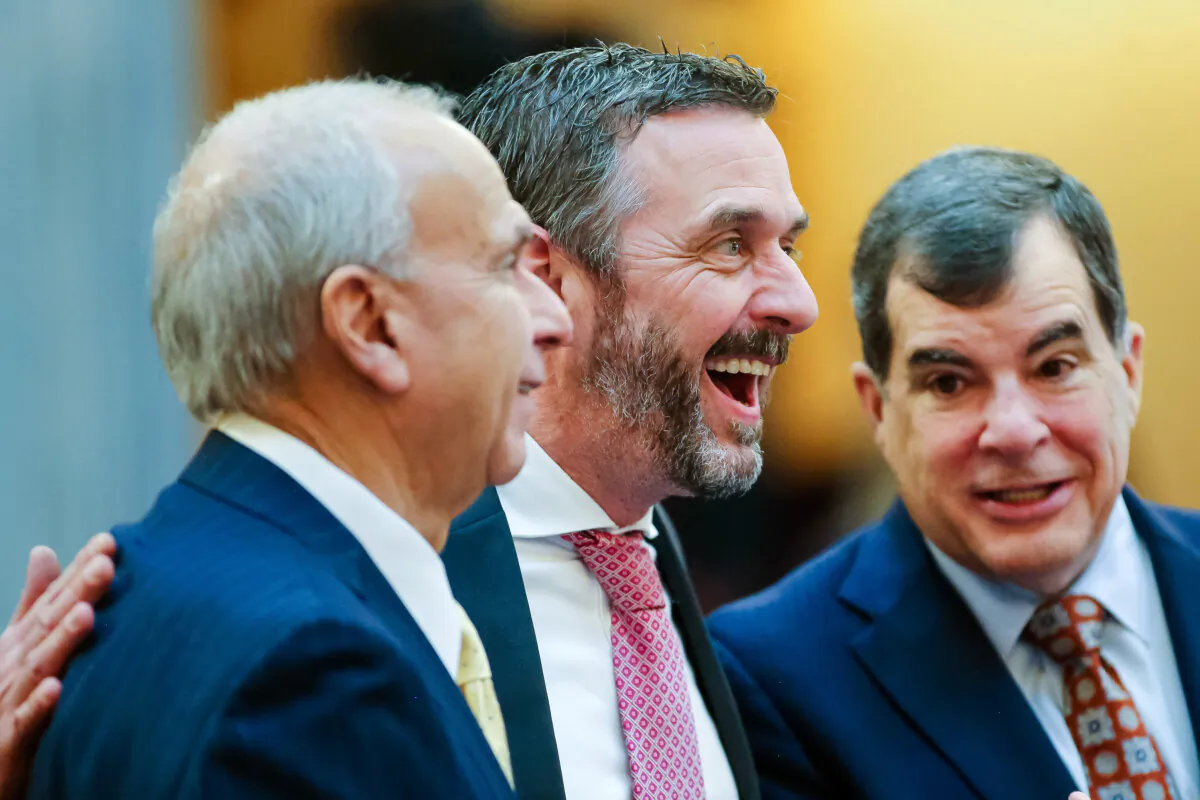 Michael Rulli, center, Ohio Senate Republican from the 33rd District, speaks with colleagues at the Ohio State House Senate Chambers in Columbus, Ohio, Wednesday, Feb. 28, 2024. (AP Photo/Joe Maiorana, File)