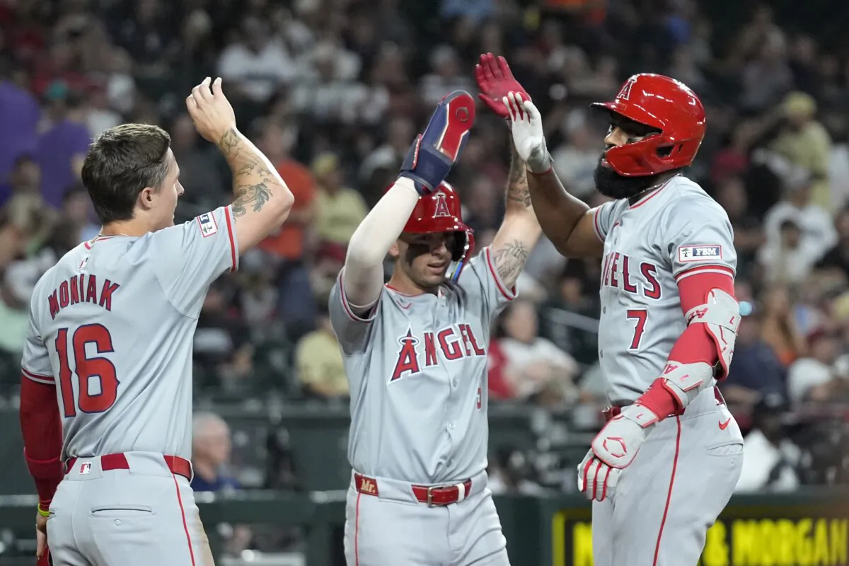 Los Angeles Angels' Jo Adell (7) celebrates his three-run home run against the Arizona Diamondbacks with Angels' Zach Neto (C) and Mickey Moniak (16) during the fourth inning of a baseball game in Phoenix on June 12, 2024. (Ross D. Franklin/AP Photo)