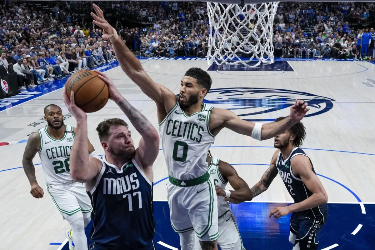 Dallas Mavericks guard Luka Doncic (77) goes up for a shot against Boston Celtics forward Jayson Tatum (0) during the second half in Game 3 of basketball's NBA Finals in Dallas on June 12, 2024. (Julio Cortez/AP Photo)