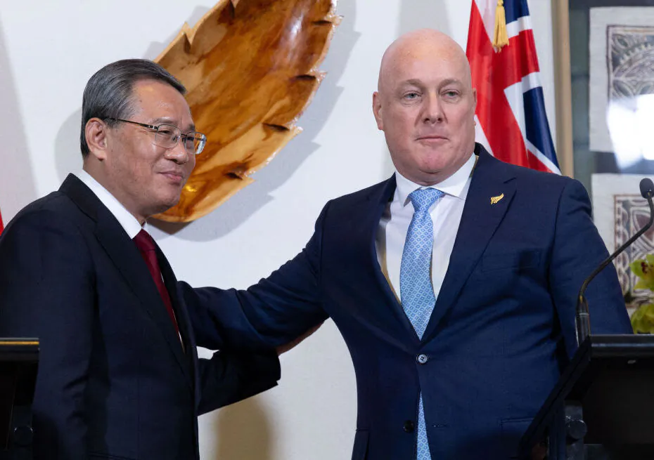 China's Premier Li Qiang (L) and New Zealand's Prime Minister Christopher Luxon pose after attending a joint press conference at Government House in Wellington on June 13, 2024. (Photo by MARTY MELVILLE/AFP via Getty Images)